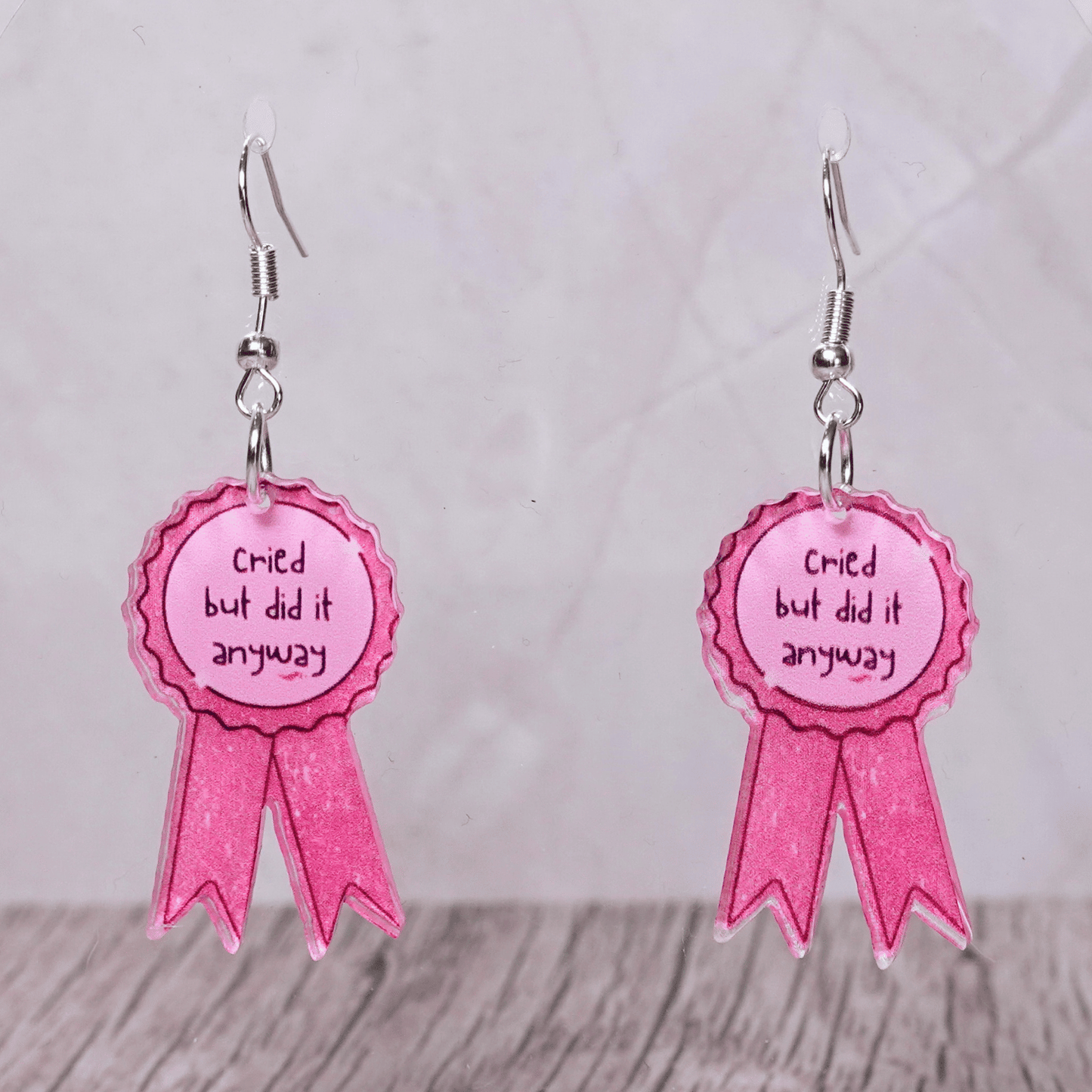 Pink award ribbon dangle earrings with text “cried but did it anyway”