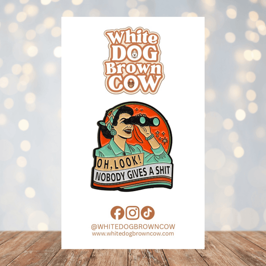 Funny sarcastic enamel pin with woman using binoculars and text “Oh look nobody gives a shit”