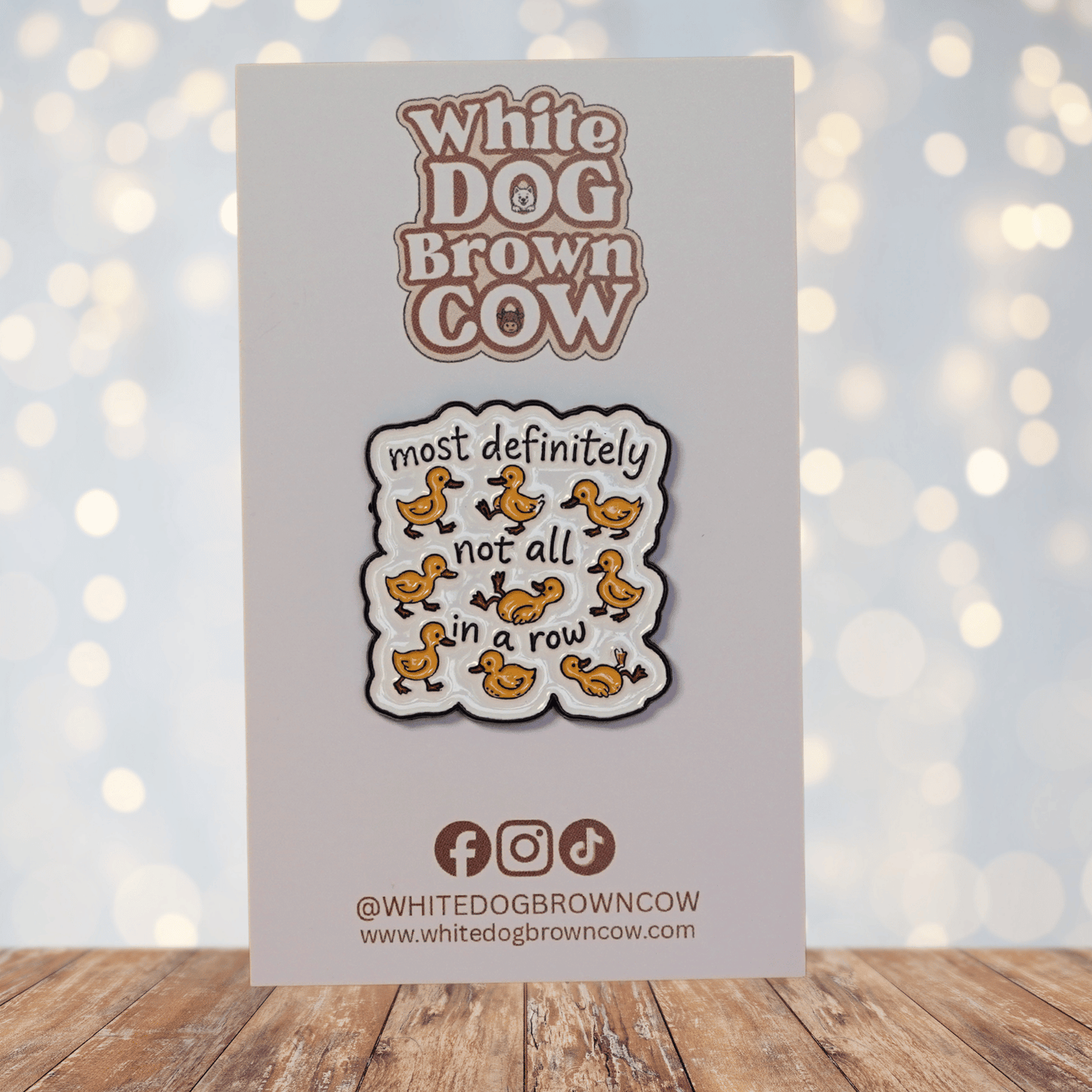 Funny sarcastic enamel pin with cartoon ducks and quote most definitely not all in a row
