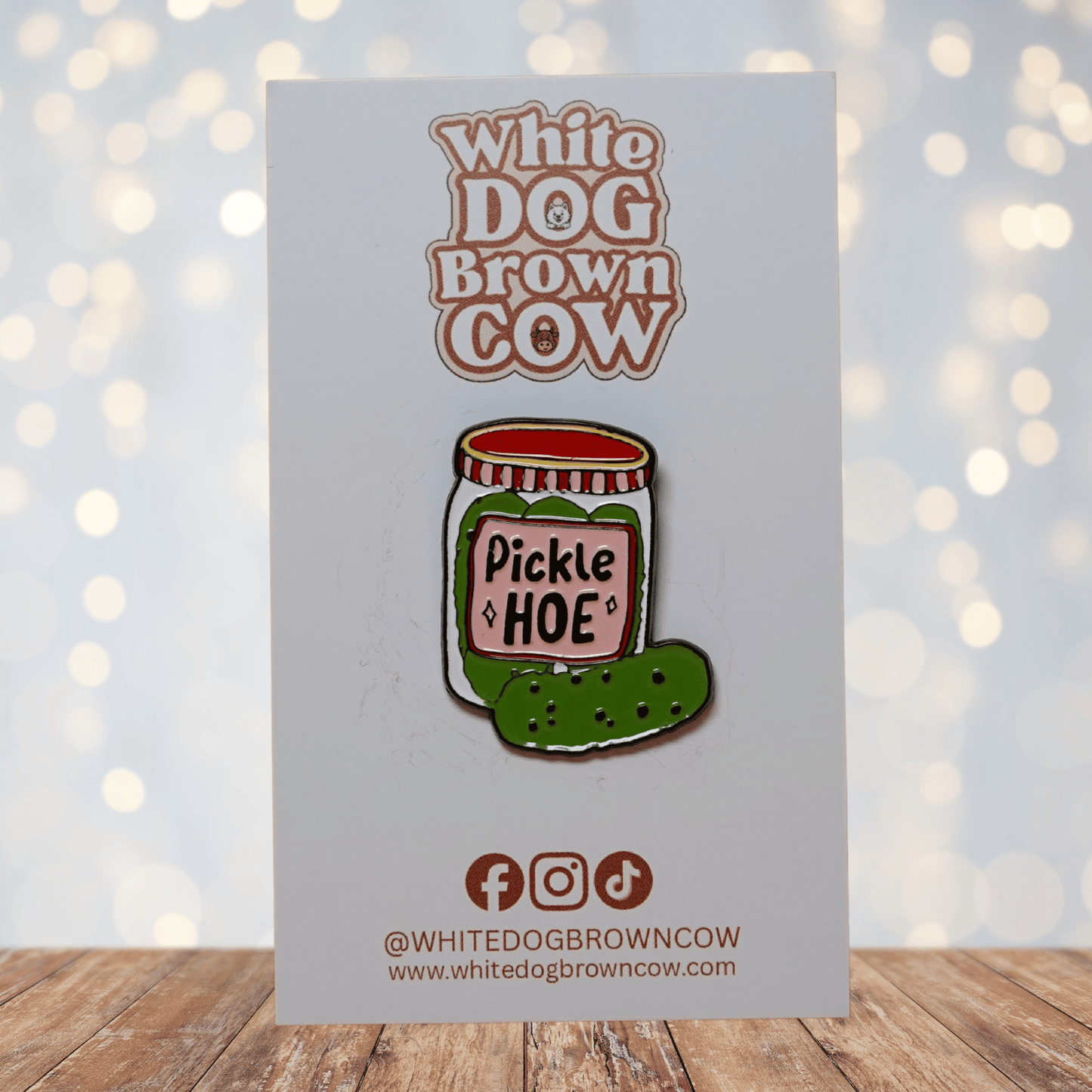 Cute enamel pin of a pickle jar labeled “Pickle Hoe” with green pickle illustration, funny food pun lapel pin.