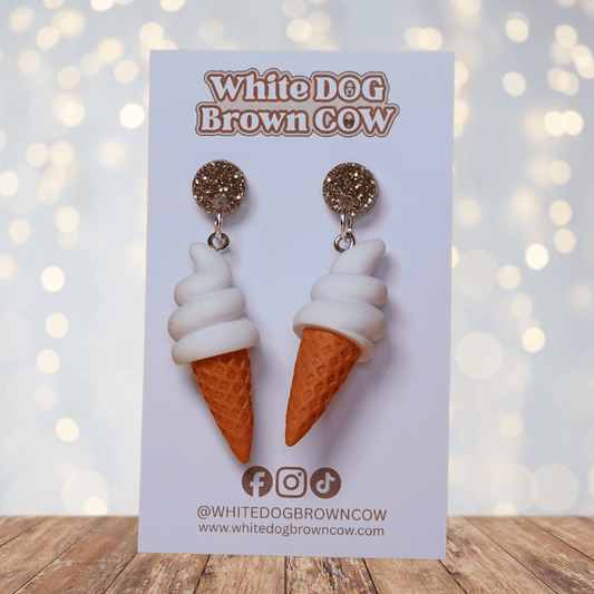 Cute dangle earrings shaped like soft serve vanilla ice cream in waffle cones.