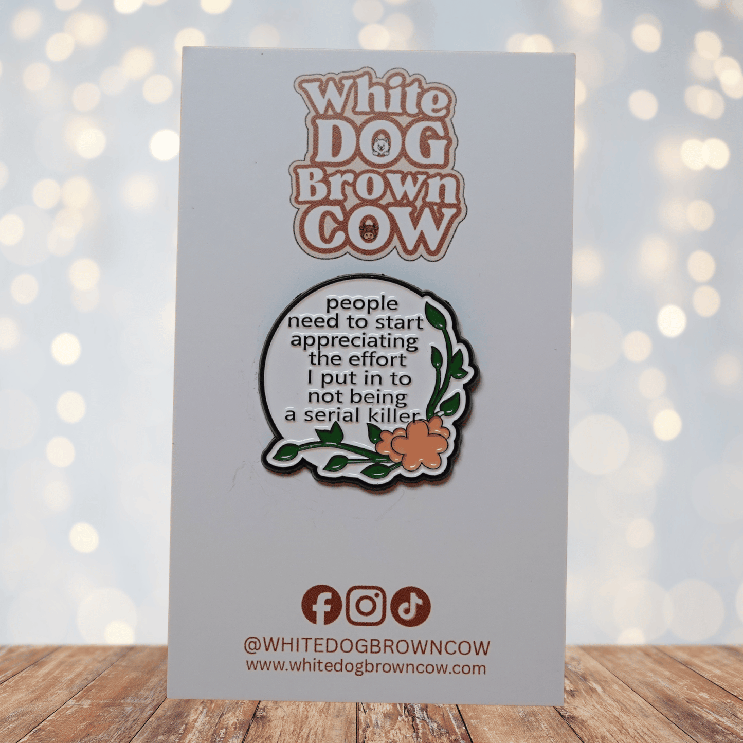 Funny dark humor enamel pin with floral design reading “People need to start appreciating the effort I put in to not being a serial killer,” sarcastic lapel pin gift.