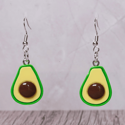Avocado shaped dangle earrings with green outline, pale yellow center and raised brown pit on silver hooks.
