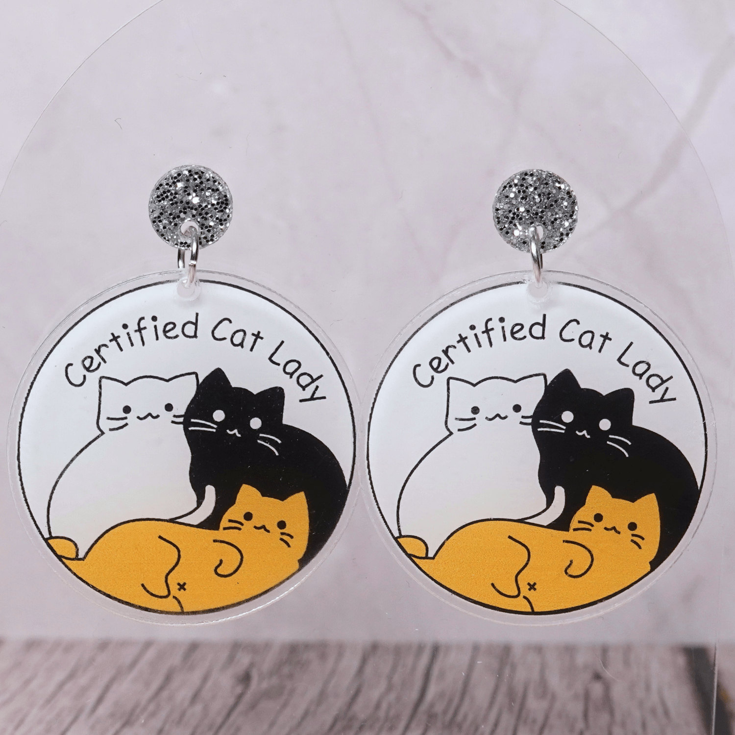 Round dangle earrings with cute cats and text “Certified Cat Lady”