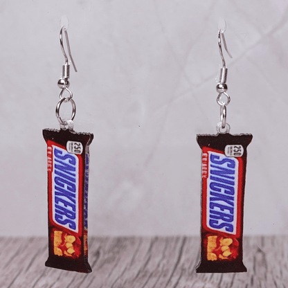 Chocolate bar shaped dangle earrings styled like a wrapped candy bar on silver hooks.
