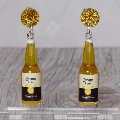 Novelty dangle earrings shaped like small beer bottles