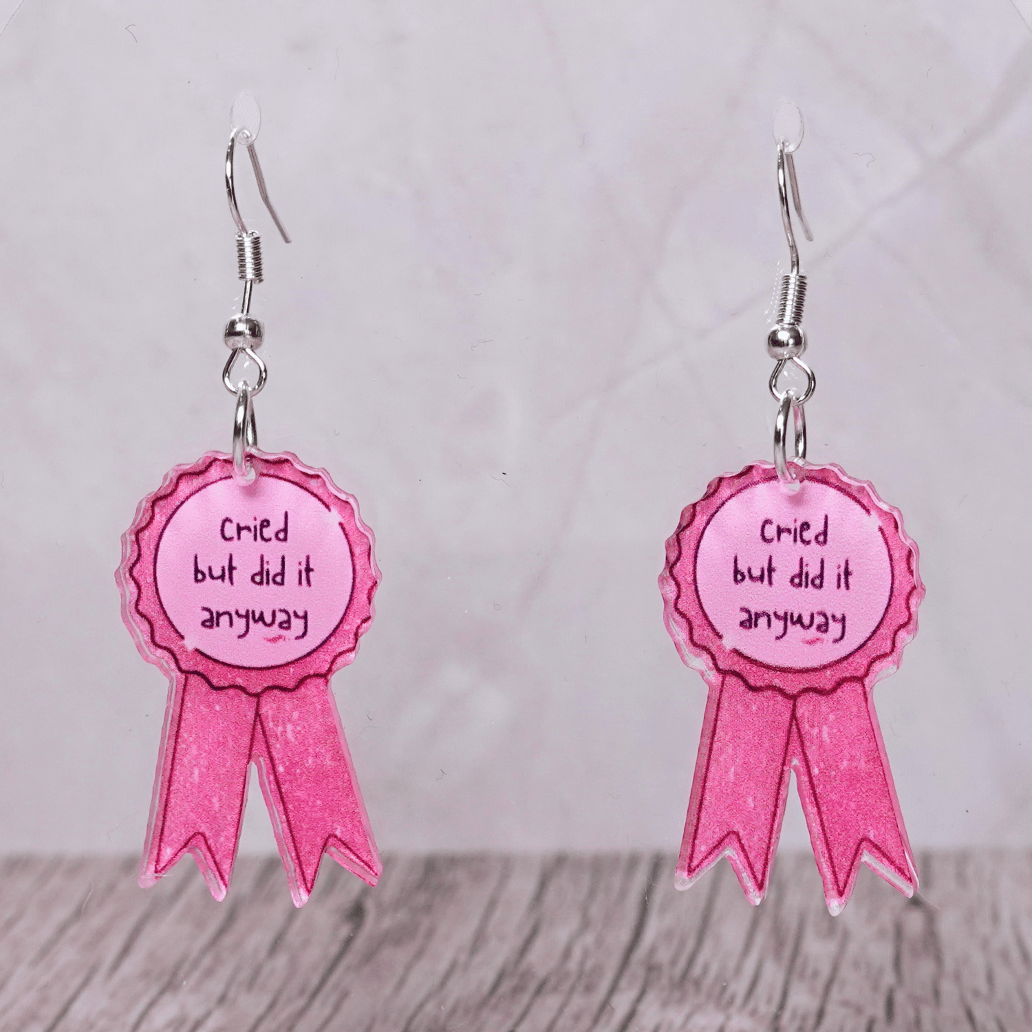 Pink award ribbon dangle earrings with text “cried but did it anyway”