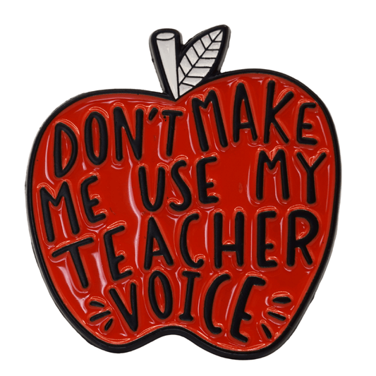 Red apple enamel pin with text “don’t make me use my teacher voice,” funny teacher gift pin