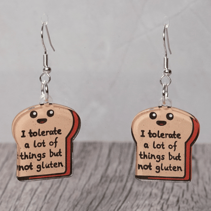 Acrylic dangle earrings shaped like a slice of bread with text reading “I tolerate a lot of things but not gluten”