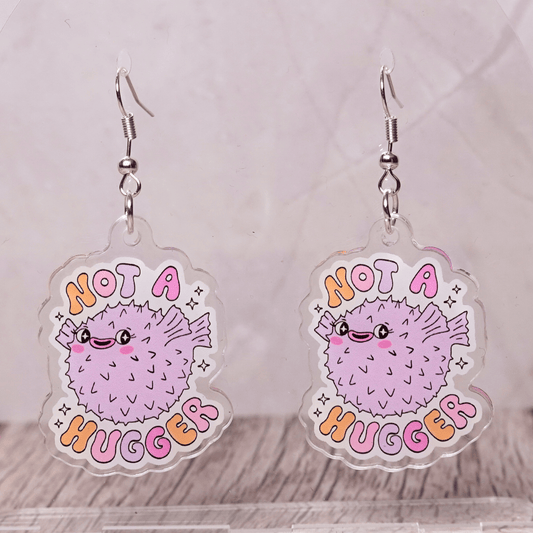 Cute pastel pufferfish dangle earrings with text “Not a Hugger”