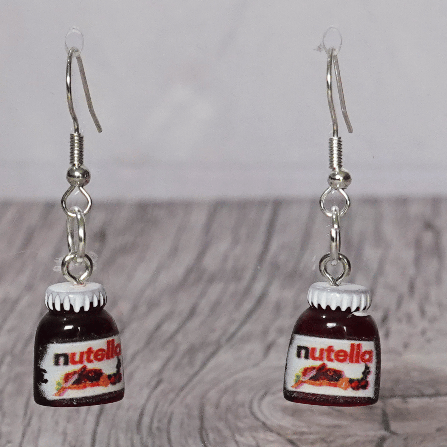Novelty dangle earrings shaped like small chocolate hazelnut spread jars with white lids