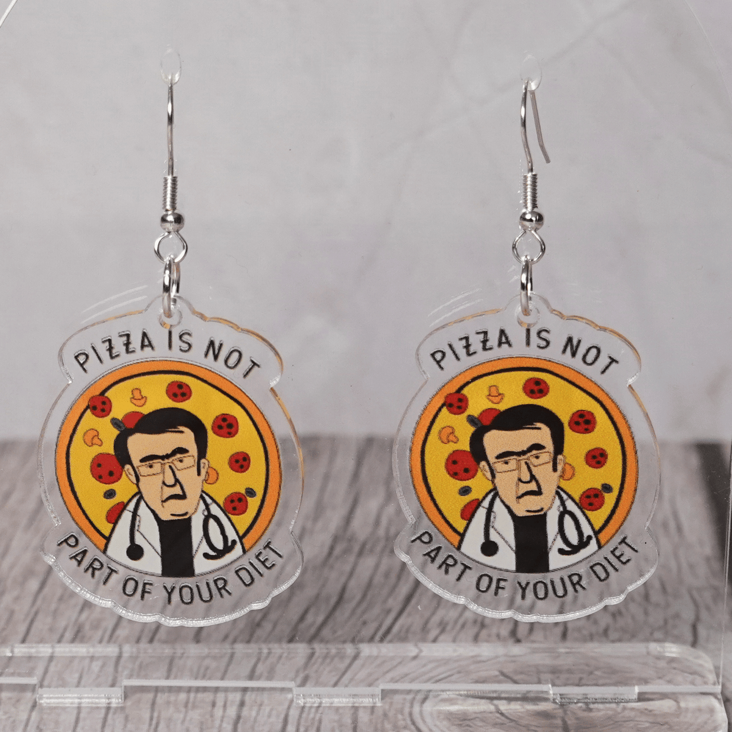 Funny acrylic dangle earrings showing Doctor Now from My 600lb Life in front of a pizza with the phrase “Pizza is not part of your diet.”