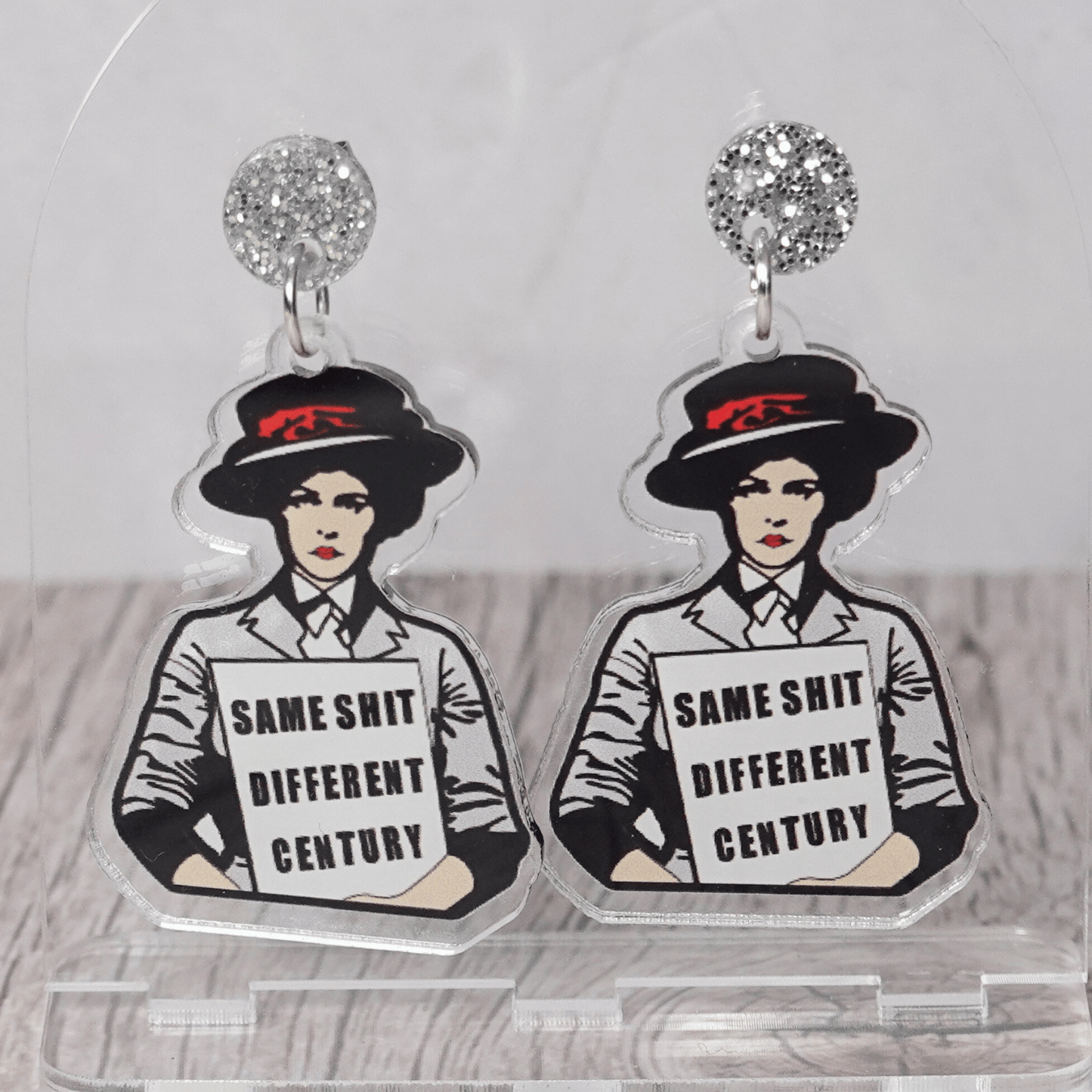 Funny acrylic dangle earrings featuring a vintage-style woman holding a sign that reads “Same shit different century.”