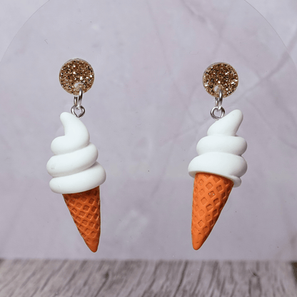 Cute dangle earrings shaped like soft serve vanilla ice cream in waffle cones.