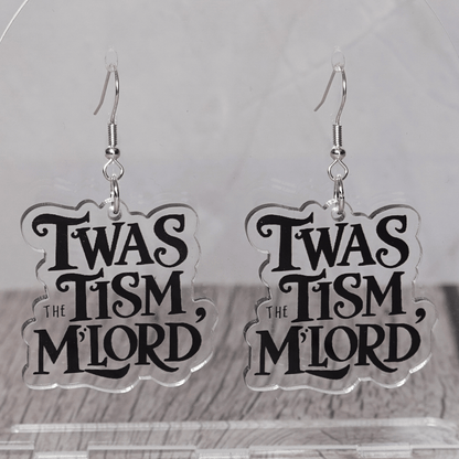 Clear acrylic dangle earrings with black text reading “‘Twas the tism, m’lord” in decorative lettering