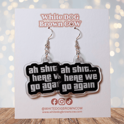 Black and white novelty earrings with text “ah shit here we go again”