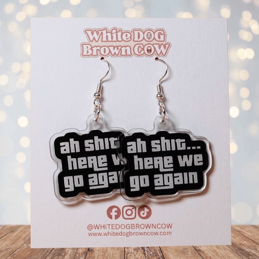 Black and white novelty earrings with text “ah shit here we go again”