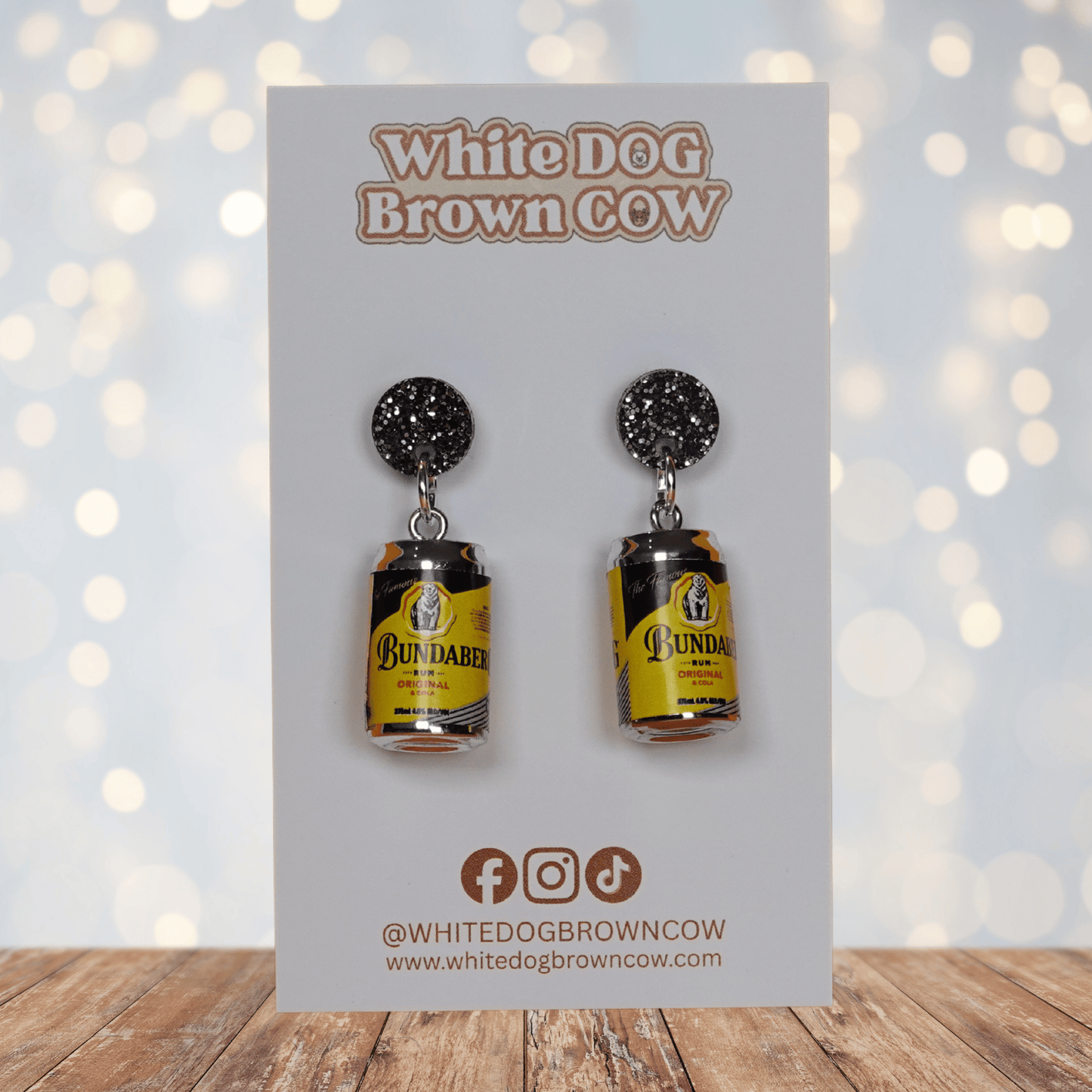Novelty dangle earrings shaped like small rum and cola drink cans