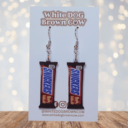 Chocolate bar shaped dangle earrings styled like a wrapped candy bar on silver hooks.