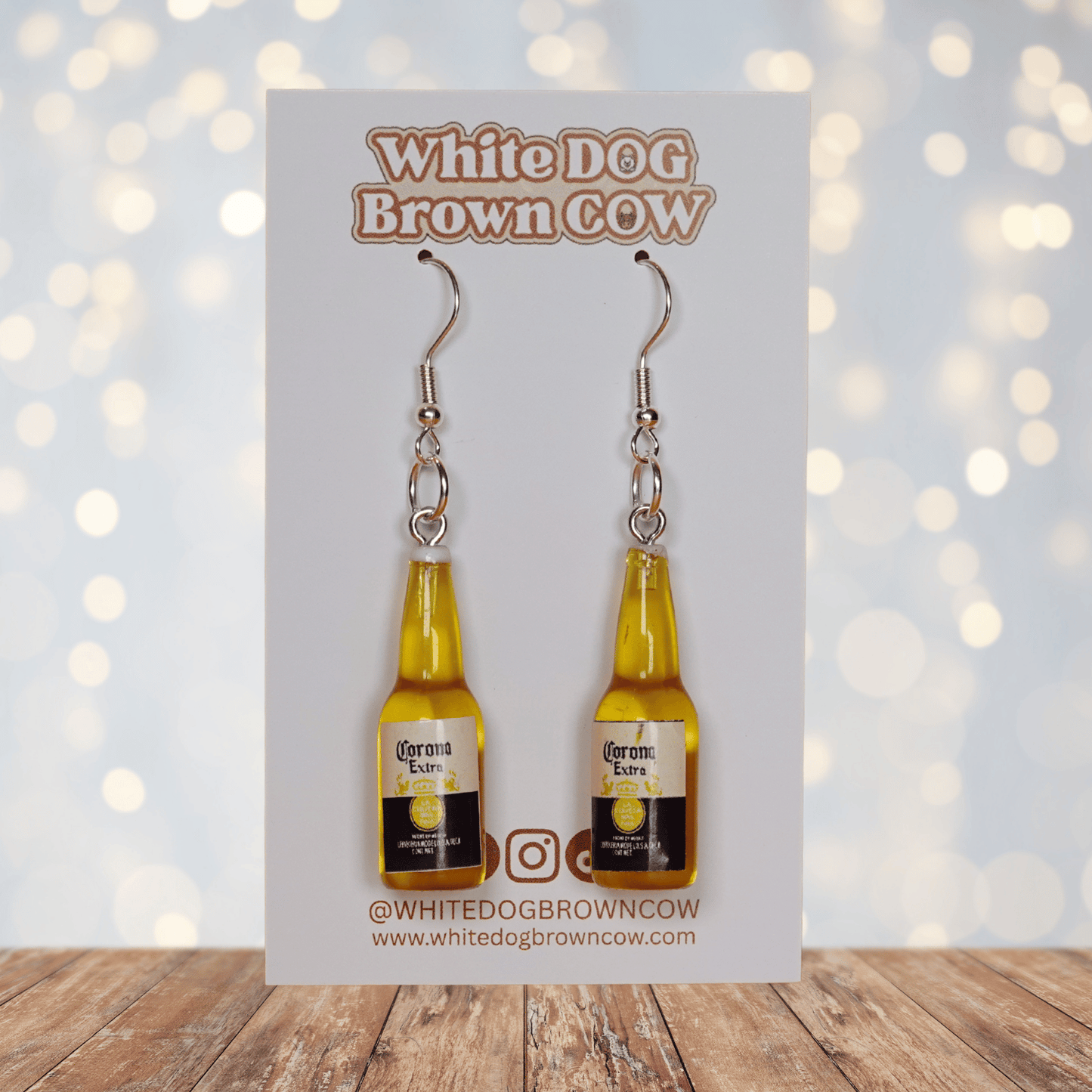 Novelty dangle earrings shaped like small beer bottles