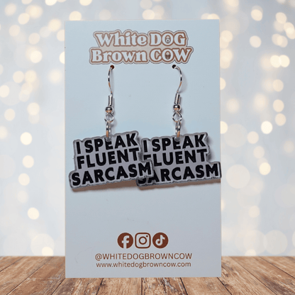 Black and white novelty earrings reading “I speak fluent sarcasm”