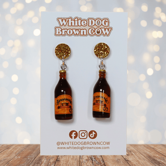 Mini brown ginger beer bottle shaped dangle earrings with orange labels and glitter studs