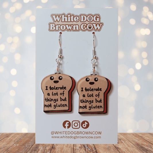 Acrylic dangle earrings shaped like a slice of bread with text reading “I tolerate a lot of things but not gluten”