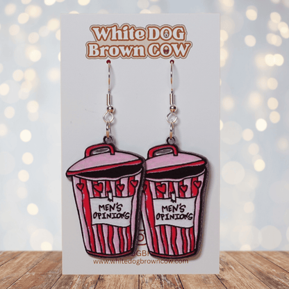 Acrylic dangle earrings shaped like a pink and red trash can labeled “Men’s Opinions”