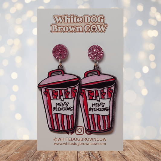 Acrylic dangle earrings shaped like a pink and red trash can labeled “Men’s Opinions”