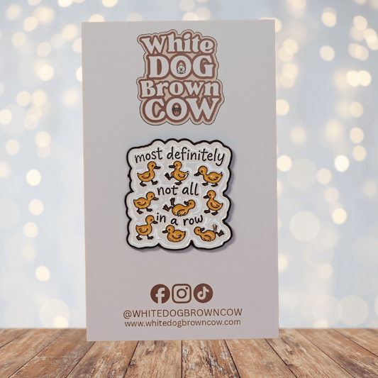 Funny sarcastic enamel pin with cartoon ducks and quote most definitely not all in a row