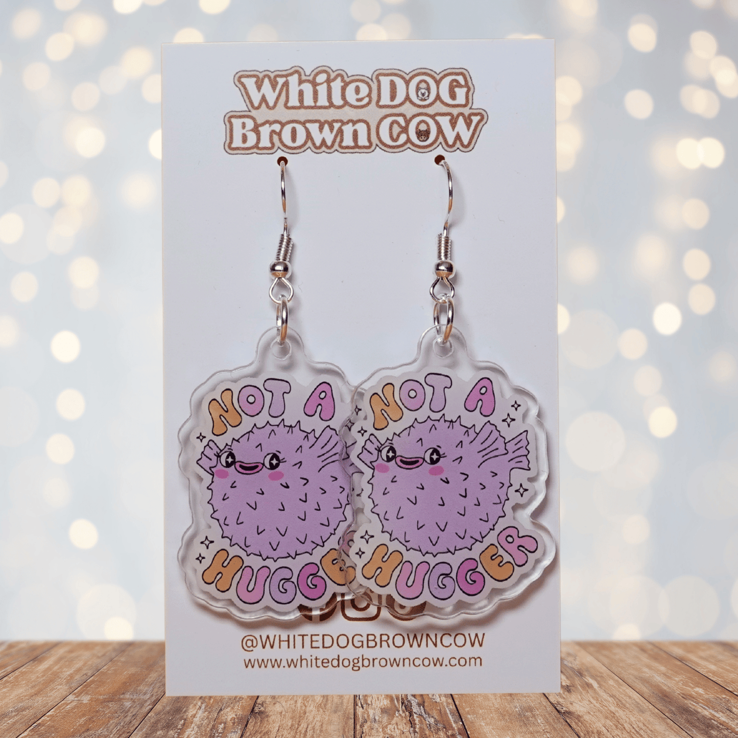 Cute pastel pufferfish dangle earrings with text “Not a Hugger”