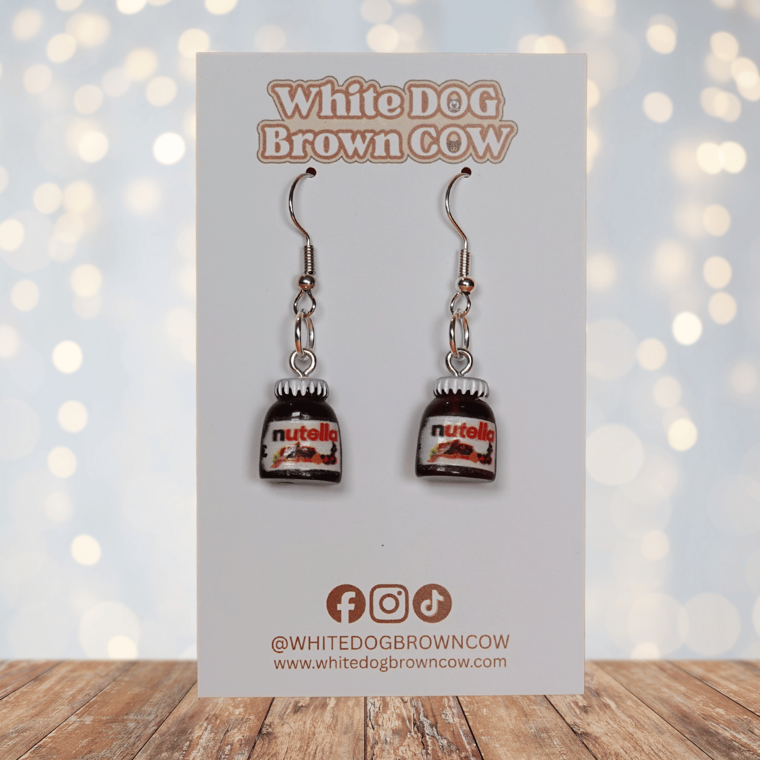 Novelty dangle earrings shaped like small chocolate hazelnut spread jars with white lids