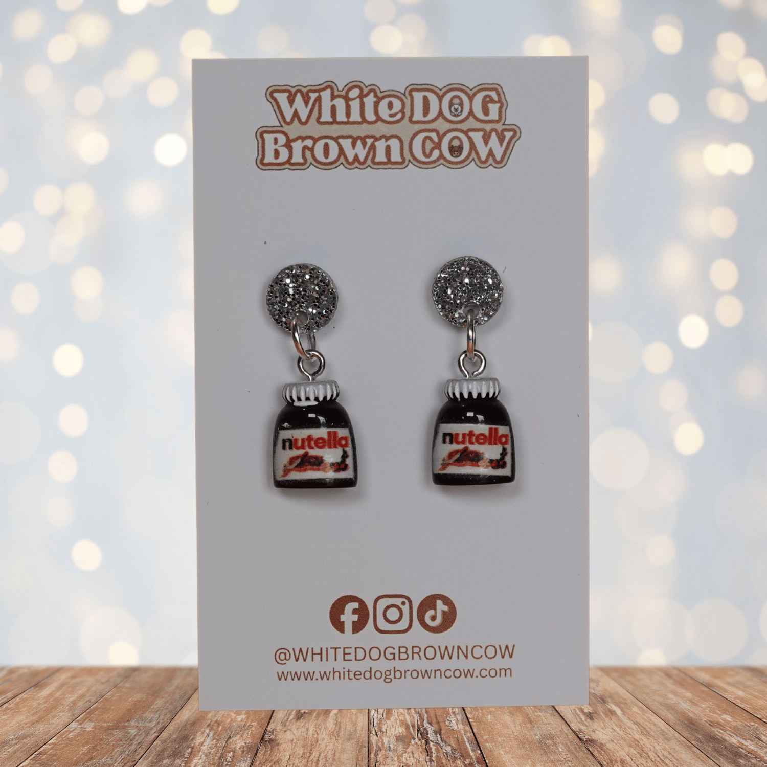 Novelty dangle earrings shaped like small chocolate hazelnut spread jars with white lids