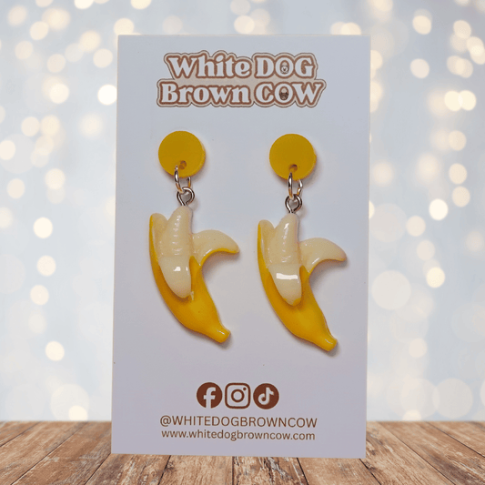 Cute dangle earrings shaped like partially peeled bananas with a realistic yellow and cream design.