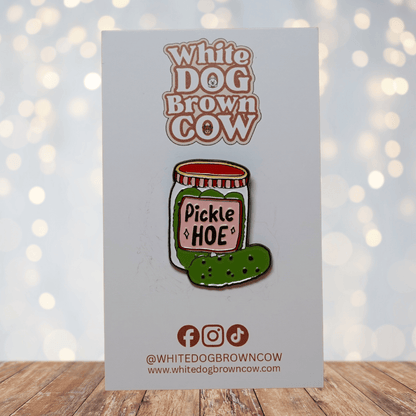 Cute enamel pin of a pickle jar labeled “Pickle Hoe” with green pickle illustration, funny food pun lapel pin.