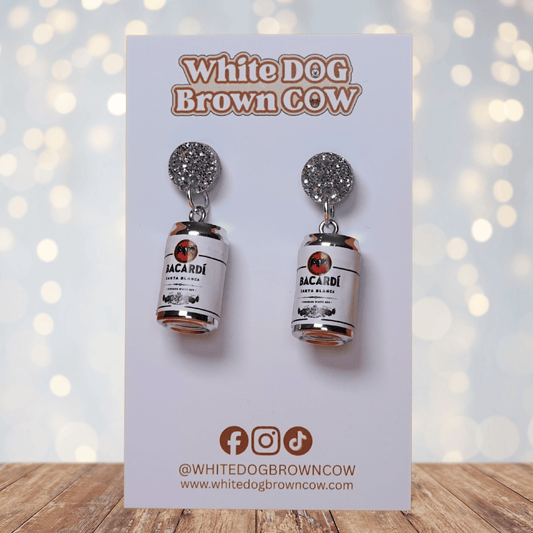 Novelty dangle earrings shaped like mini white rum cans with a printed label design and silver glitter studs.